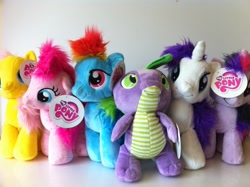 Size: 1023x764 | Tagged: safe, derpibooru import, fluttershy, pinkie pie, rainbow dash, rarity, spike, twilight sparkle, fluffy, irl, my little pony logo, official, photo, plushie, rarity plushie, spike plushie