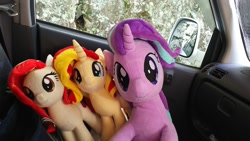 Size: 1200x675 | Tagged: safe, artist:nekokevin, starlight glimmer, sunset shimmer, oc, oc:poniko, earth pony, pony, unicorn, series:nekokevin's glimmy, car, car seat, female, irl, looking at you, mare, photo, plushie, sitting, size difference, smiling