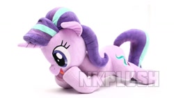 Size: 1280x720 | Tagged: safe, alternate version, artist:nekokevin, starlight glimmer, pony, unicorn, series:nekokevin's glimmy, female, irl, lying down, mare, obtrusive watermark, open mouth, photo, plushie, raised hoof, simple background, smiling, solo, watermark, white background