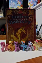 Size: 3072x4608 | Tagged: safe, derpibooru import, applejack, fluttershy, pinkie pie, rainbow dash, rarity, twilight sparkle, blind bag, book, elements of harmony, figure, irl, mane six, merchandise, photo, toy