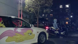 Size: 599x337 | Tagged: safe, fluttershy, rainbow dash, 2014, brony, car, clothes, convention, custom, decal, hoodie, irl, itasha, japan, japan ponycon, motorcycle, night, photo
