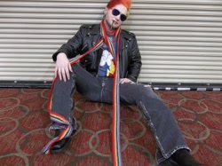 Size: 1034x772 | Tagged: safe, artist:ichankobayashi, rainbow blitz, rainbow dash, human, 2013, a-kon, clothes, convention, cosplay, irl, irl human, jacket, photo, rule 63, scarf, sitting, solo, sunglasses