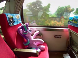 Size: 2048x1536 | Tagged: safe, artist:nekokevin, starlight glimmer, pony, unicorn, series:nekokevin's glimmy, ><, eyes closed, female, irl, mare, open mouth, photo, plushie, raised hoof, seat, sitting, smiling, solo, train