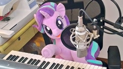 Size: 1024x577 | Tagged: safe, artist:nekokevin, starlight glimmer, pony, unicorn, series:nekokevin's glimmy, chair, female, irl, keyboard, looking at you, mare, microphone, musical instrument, open mouth, photo, plushie, sewing machine, sitting, smiling, solo, underhoof