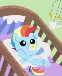 Size: 531x651 | Tagged: safe, derpibooru import, rainbow dash, pegasus, pony, parental glideance, baby, baby dash, baby pony, crib, diaper, foal, pacifier, solo