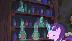 Size: 1920x1080 | Tagged: safe, screencap, snowfall frost, starlight glimmer, pony, unicorn, a hearth's warming tail, bottle, female, glasses, magic, magic aura, mare, mid-blink screencap, pince-nez, solo, telekinesis