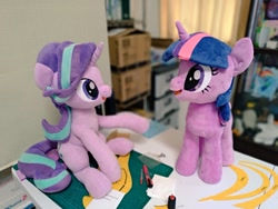 Size: 1024x768 | Tagged: safe, artist:nekokevin, starlight glimmer, twilight sparkle, unicorn twilight, pony, unicorn, series:nekokevin's glimmy, desk, duo, female, irl, looking at each other, mare, open mouth, photo, plushie, raised hoof, sitting, smiling