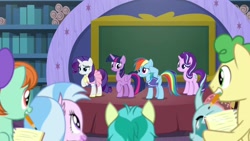 Size: 1920x1080 | Tagged: safe, screencap, huckleberry, ocellus, peppermint goldylinks, rainbow dash, rarity, sandbar, silverstream, starlight glimmer, twilight sparkle, twilight sparkle (alicorn), alicorn, pegasus, pony, unicorn, the end in friend, camping outfit, chalkboard, clothes, dress, female, friendship student, jersey, mare, mouth hold, notepad, pencil, school of friendship, shirt, stage