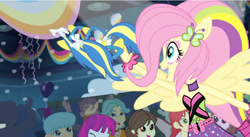 Size: 852x468 | Tagged: safe, screencap, brawly beats, bright idea, crimson napalm, curly winds, drama letter, fluttershy, mystery mint, nolan north, ringo, some blue guy, sophisticata, teddy t. touchdown, thunderbass, valhallen, velvet sky, watermelody, equestria girls, rainbow rocks, shake your tail, background human, crowd, cute, female, huggable, male, ponied up, shyabetes