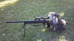 Size: 960x540 | Tagged: artist needed, safe, derpy hooves, pegasus, pony, female, ghillie suit, grass, gun, irl, mare, photo, plushie, rifle, weapon