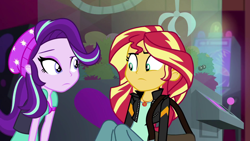 Size: 1920x1080 | Tagged: safe, screencap, starlight glimmer, sunset shimmer, equestria girls, mirror magic, spoiler:eqg specials, beanie, claw machine, female, hat, looking at each other, messenger bag
