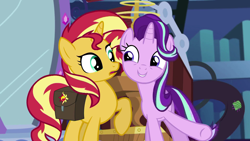 Size: 1920x1080 | Tagged: safe, screencap, starlight glimmer, sunset shimmer, pony, unicorn, equestria girls, mirror magic, spoiler:eqg specials, confused, cute, duo, excited, eye contact, female, glimmerbetes, grin, happy, library, looking at each other, mare, mirror, open mouth, raised hoof, saddle bag, smiling, twilight's castle, underhoof