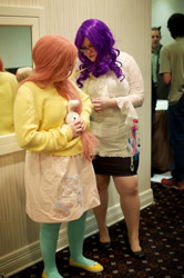 Size: 1275x1920 | Tagged: safe, artist:chubcakes, fluttershy, rarity, human, 2012, brony fan fair, clothes, convention, cosplay, glasses, irl, irl human, measuring tape, photo, plushie, sweater, sweatershy