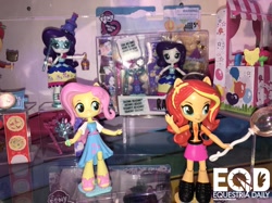 Size: 1210x907 | Tagged: safe, screencap, fluttershy, rarity, sunset shimmer, equestria girls, equestria girls series, clothes, doll, dress, equestria girls logo, equestria girls minis, jacket, sandals, shoes, skirt, toy, toy fair, toy fair 2018