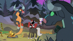 Size: 1920x1080 | Tagged: safe, screencap, cozy glow, lord tirek, queen chrysalis, centaur, changeling, changeling queen, ophiotaurus, pegasus, pony, frenemies (episode), campfire, clothes, cloven hooves, disguise, disguised changeling, female, filly, flying, foal, forest, hat, log, male, nose piercing, nose ring, open mouth, piercing, pine tree, tree, tree stump, winter outfit