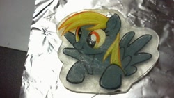 Size: 640x360 | Tagged: safe, artist:melinda chovexani, derpy hooves, pegasus, pony, female, keychain, mare, scrunchy face, shrinky dink