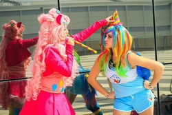 Size: 740x493 | Tagged: safe, artist:kikyo kompa, artist:miyako, derpibooru import, pinkie pie, rainbow dash, human, cosplay, dressing, hat, irl, irl human, party hat, party horn, photo, romics, unamused