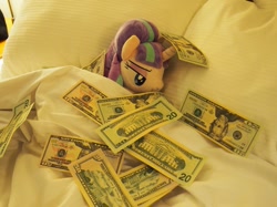 Size: 1067x800 | Tagged: safe, artist:onlyfactory, starlight glimmer, pony, unicorn, $tarlight glimmer, bed, blanket, capitalism, capitalist communist, irl, lidded eyes, make it rain, money, photo, pillow, plushie, solo