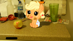 Size: 1024x576 | Tagged: safe, artist:goldenponyz, artist:tenebristayga, applejack, apple, babyjack, bottle, counter, diaper, glass, irl, kitchen, photo, ponies in real life, shadow, vector