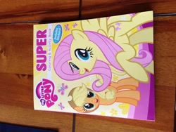 Size: 3264x2448 | Tagged: safe, applejack, fluttershy, book, irl, merchandise, photo, sideways image