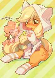 Size: 564x800 | Tagged: safe, artist:rikose, applejack, pinkie pie, cat, earth pony, pony, applecat, blushing, cat ears, cat hoodie, cat paws, cat's pajamas, clothes, costume, cute, embarrassed, eyes closed, hoodie, hoof hold, jackabetes, japanese, kigurumi, microphone, open mouth, sitting, smiling, socks, striped socks, sweatdrop, translated in the comments