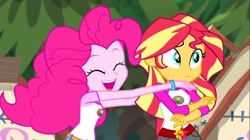 Size: 1100x618 | Tagged: safe, screencap, pinkie pie, sunset shimmer, equestria girls, legend of everfree, bracelet, camp everfree outfits, eyes closed, incoming hug, jewelry, sun