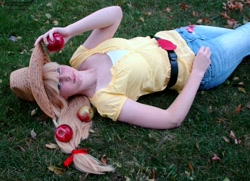 Size: 1600x1159 | Tagged: safe, artist:mickeydoo13, applejack, human, apple, cosplay, grass, irl, irl human, obligatory apple, on back, photo, solo