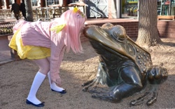 Size: 4072x2524 | Tagged: safe, artist:lochlan o'neil, fluttershy, frog, human, brick wall, clothes, cosplay, craft, crouching, day, dress, female, hairpin, human female, irl, irl human, kissing, photo, railing, sculpture, skirt, solo, statue, sweater, sweatershy, tail, touching face, tree