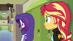 Size: 1100x618 | Tagged: safe, screencap, rarity, sunset shimmer, equestria girls, friendship games, clothes, hallway, jacket, leather jacket, lockers, rear view, skirt