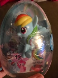 Size: 360x480 | Tagged: safe, derpibooru import, rainbow dash, figure, hand, irl, jelly bean, photo, sitting, solo, toy