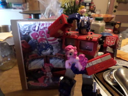 Size: 1024x768 | Tagged: safe, idw, pinkie pie, earth pony, pony, comic, merchandise, optimus prime, toy, transformers