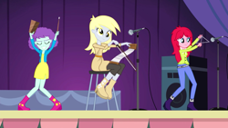 Size: 1280x720 | Tagged: safe, screencap, blueberry pie, derpy hooves, raspberry fluff, equestria girls, rainbow rocks, background human, cowbell, kimber benton, musical instrument, musical saw, saw, smiling, stage, the muffins, triangle, trio