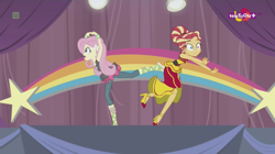 Size: 1136x638 | Tagged: safe, screencap, fluttershy, sunset shimmer, dance magic, equestria girls, spoiler:eqg specials, accident, alternate hairstyle, awkward moment, canterlot high, clothes, dancing, dress, duo, female, high heels, rainbow, shoes, skirt, stars, teletoon, tutu