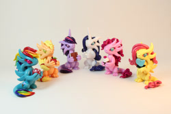 Size: 1024x683 | Tagged: safe, artist:shaidyskydesign, derpibooru import, applejack, fluttershy, pinkie pie, rainbow dash, rarity, twilight sparkle, dragon, apple, book, craft, cupcake, d20, dice, dragonjack, flutterdragon, food, mane six, pinkiedragon, rainbow dragon, raridragon, sculpture, species swap, twilidragon