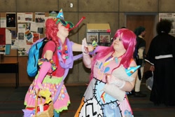 Size: 2048x1366 | Tagged: artist needed, safe, madame leflour, pinkie pie, human, 2013, backpack, clothes, convention, cosplay, duality, fight, fingerless gloves, gloves, hat, irl, irl human, party hat, photo, pinkamena diane pie, rubber duck, tsukino-con