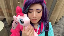 Size: 1280x720 | Tagged: safe, artist:nyakoppp, pinkie pie, starlight glimmer, human, pony, equestria girls, beanie, clothes, cosplay, costume, duo, eyes closed, hat, holding a pony, irl, irl human, photo, plushie