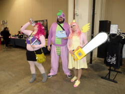 Size: 2592x1944 | Tagged: artist needed, safe, fluttershy, pinkie pie, spike, human, .mov, chainsaw, clothes, convention, cosplay, hoodie, irl, irl human, katsucon, photo, pony.mov, weapon