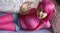 Size: 1024x579 | Tagged: safe, artist:amphyrainbows, pinkie pie, human, bed, cosplay, irl, irl human, looking at you, photo, solo, suspenders, waving