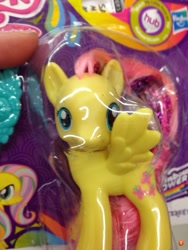 Size: 768x1024 | Tagged: safe, fluttershy, g4, box, brushable, error, factory error, irl, made in china, mismatched eyes, photo, rainbow power, toy, wat, you had one job