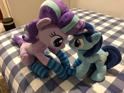 Size: 2048x1536 | Tagged: safe, artist:nekokevin, starlight glimmer, oc, oc:sierra nightingale, pegasus, pony, unicorn, series:nekokevin's glimmy, bed, canon x oc, clothes, female, glimmgale, irl, male, mare, photo, plushie, sitting, size difference, smiling, socks, stallion, striped socks