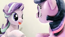 Size: 1024x576 | Tagged: safe, artist:nekokevin, starlight glimmer, twilight sparkle, unicorn twilight, pony, unicorn, series:nekokevin's glimmy, duo, female, irl, looking at each other, mare, open mouth, photo, plushie, raised hoof, sideways, sitting, smiling, underhoof