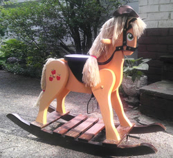 Size: 1600x1461 | Tagged: safe, applejack, earth pony, pony, blonde mane, female, mare, orange coat, photo, rocking horse, solo