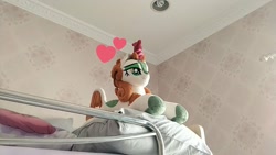 Size: 1024x576 | Tagged: safe, artist:burgunzik, autumn blaze, kirin, sounds of silence, bed, female, heart, irl, lidded eyes, photo, pillow, plushie, prone, smiling, solo