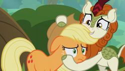 Size: 1013x578 | Tagged: safe, derpibooru import, screencap, applejack, autumn blaze, earth pony, kirin, pony, season 8, sounds of silence, spoiler:s08, female, hug, mare