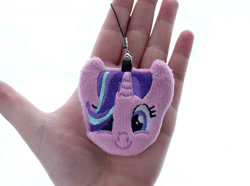 Size: 1343x1000 | Tagged: safe, alternate version, artist:meplushyou, starlight glimmer, human, pony, unicorn, charm, female, hair over one eye, hand, irl, irl human, looking at you, mare, photo, plushie, smiling