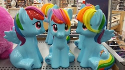 Size: 960x540 | Tagged: safe, derpibooru import, rainbow dash, ceramic, dashstorm, doll, irl, multeity, my little pony logo, photo, sitting, toy, triality, trio, triple rainbow, walmart