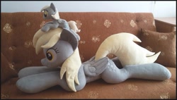 Size: 1155x655 | Tagged: safe, artist:rosamariposacrafts, derpy hooves, pony, irl, life size, photo, plushie, prone, self ponidox, size difference, sofa