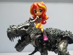 Size: 1024x768 | Tagged: safe, artist:lonetrekker, sunset shimmer, dinosaur, equestria girls, action figure, boots, clothes, dinobot, doll, equestria girls minis, grimlock, jacket, riding, shoes, skirt, toy, transformers, transformers age of extinction