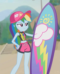 Size: 585x718 | Tagged: safe, derpibooru import, screencap, rainbow dash, better together, blue crushed, equestria girls, belly button, cap, clothes, cropped, female, geode of super speed, hat, legs, magical geodes, midriff, shorts, smiling, surfboard, swimsuit