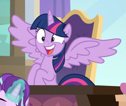 Size: 741x624 | Tagged: safe, screencap, starlight glimmer, twilight sparkle, twilight sparkle (alicorn), alicorn, pony, unicorn, sparkle's seven, cropped, desk, excited, faic, female, gasp, glowing horn, horn, magic, mare, offscreen character, open mouth, sitting, solo focus, spread wings, wide eyes, wings